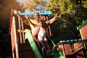 Father and son having fun on toboggan.