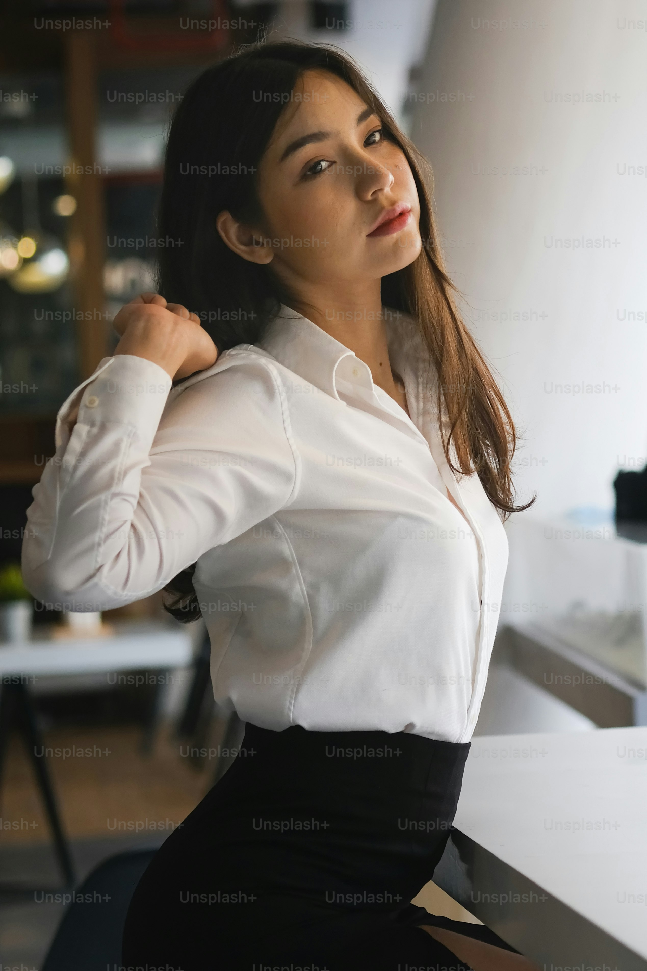 Portrait of businesswoman relaxing and stretching her arms in office.