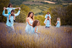 Large group of people in lavender field. Focus is on foreground