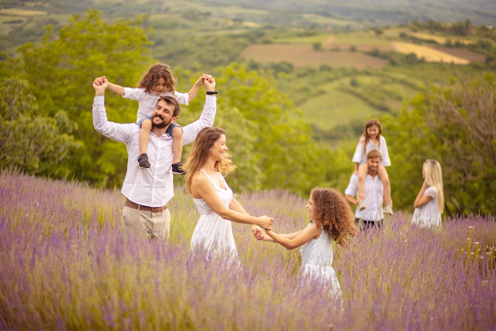 Large group of people in lavender field. Focus is on foreground