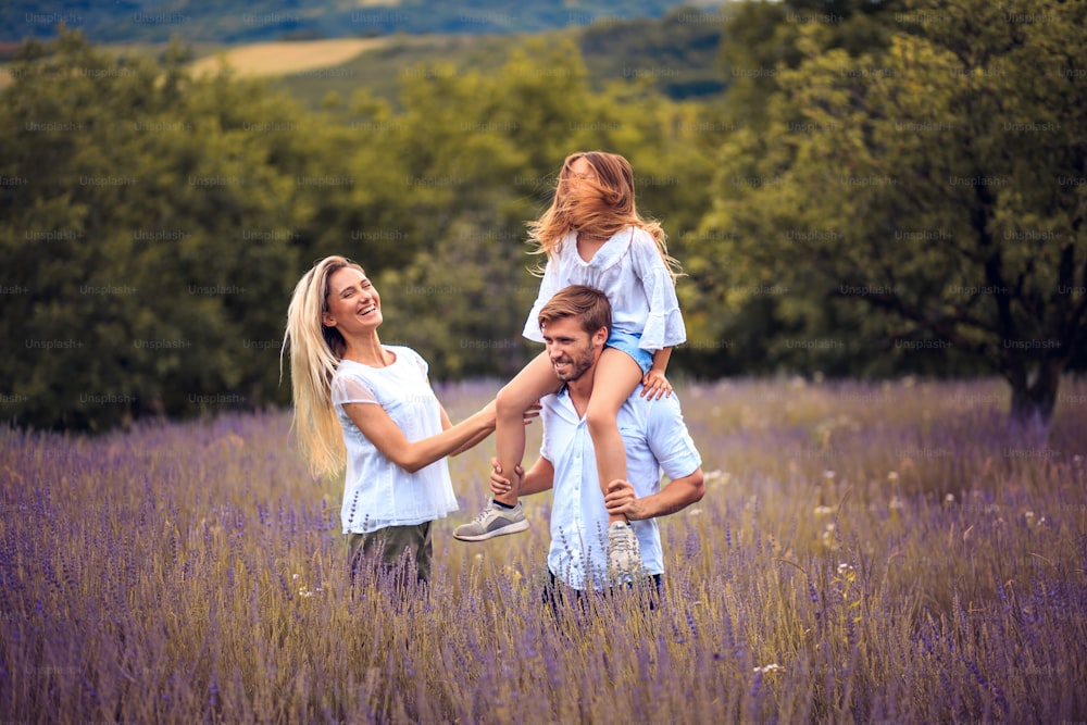 라벤더 밭에서 웃고 있는 가족의 초상화.