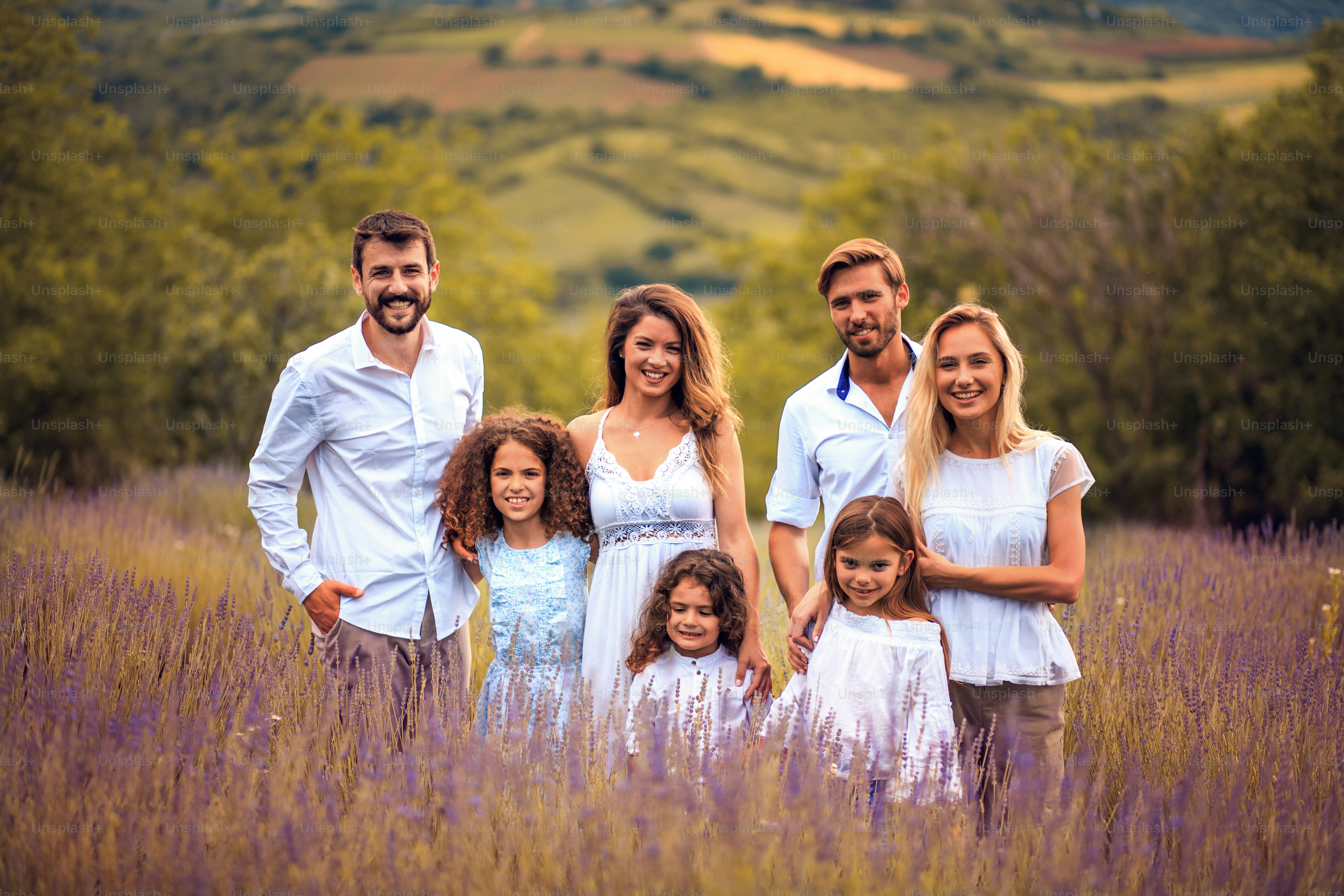 Large group of people standing in lavender filed.