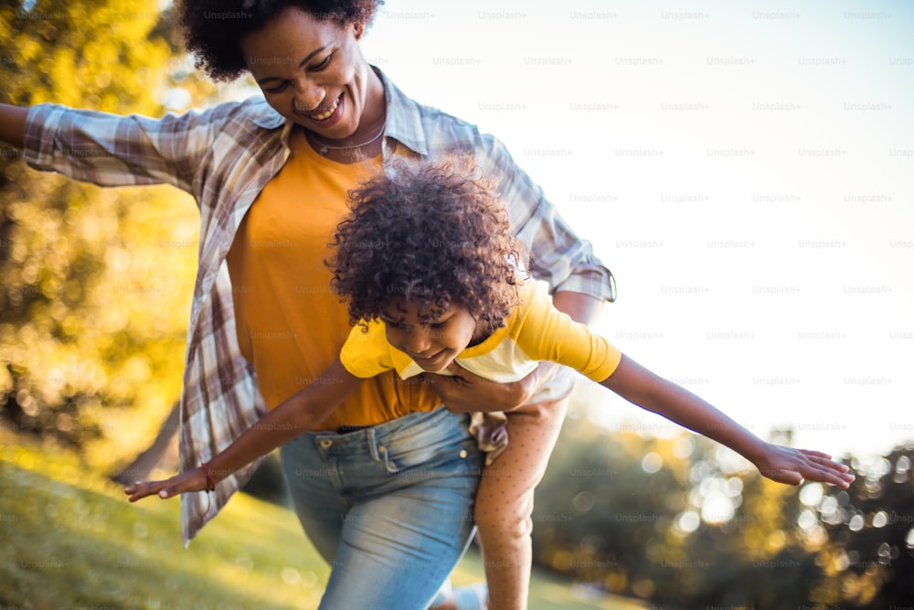 African American mother and daughter playing in the park.