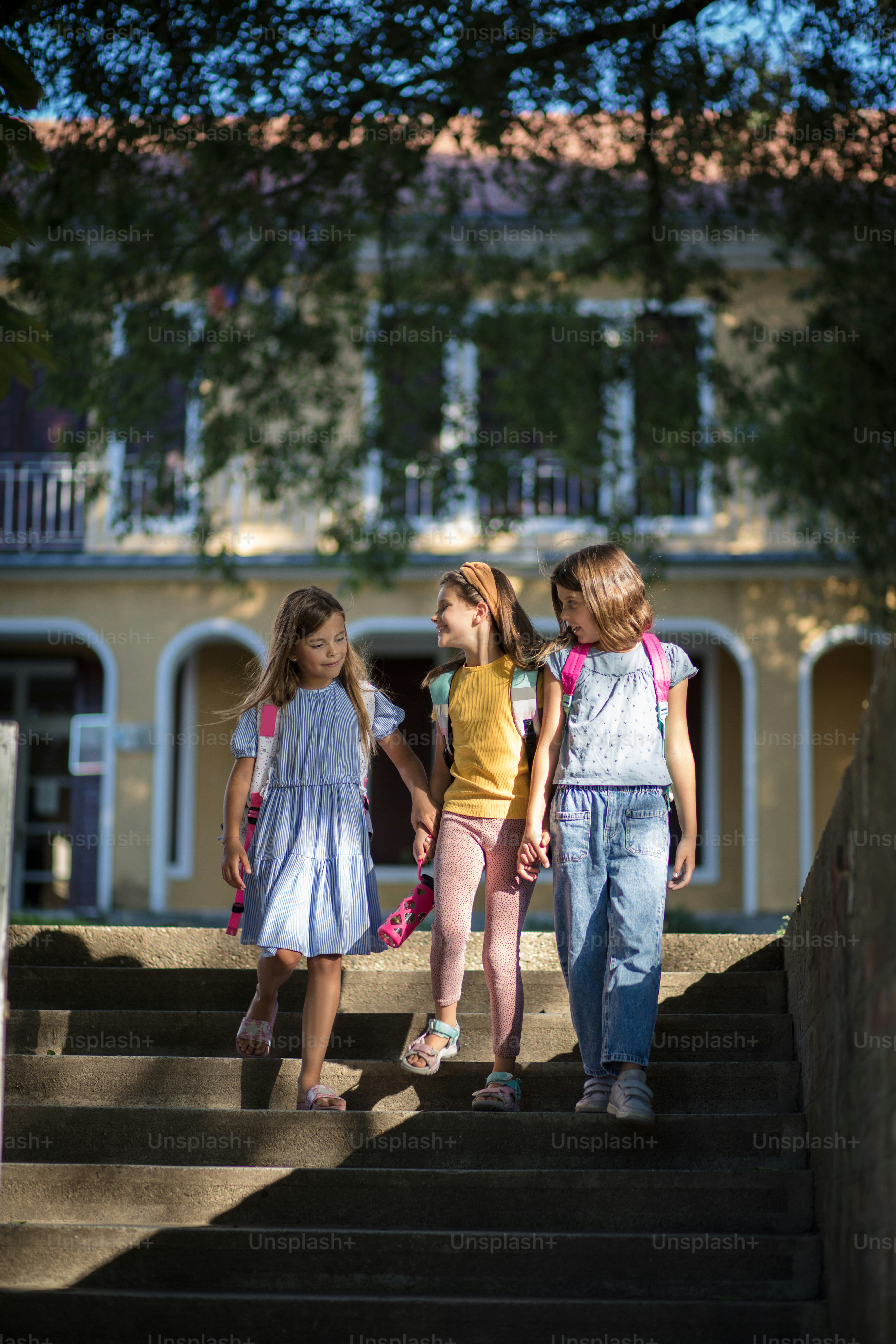Completed school day. The three girls return from school together.