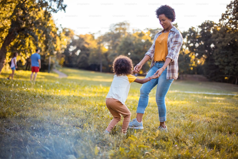 African American mother and daughter playing in nature.