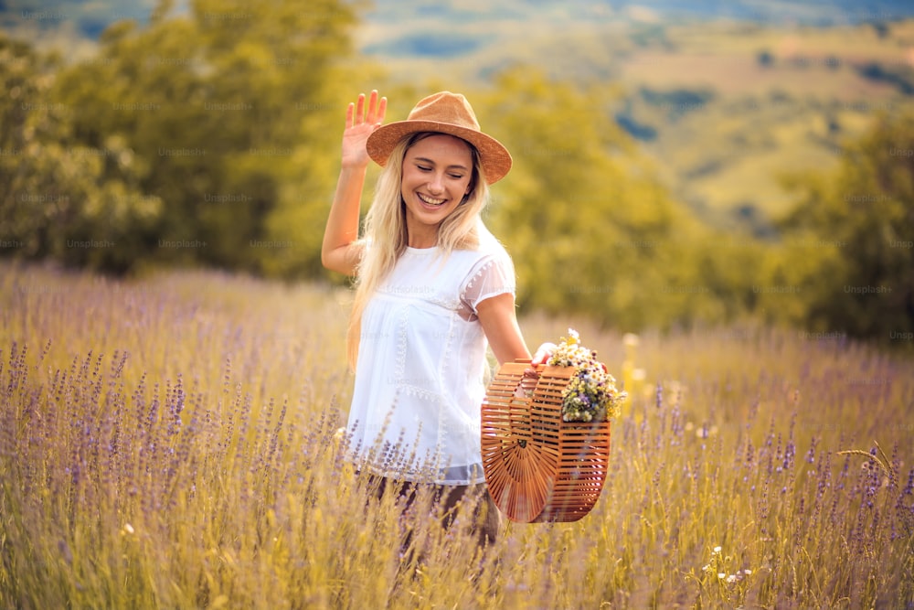Happy and smiling. Young smiling Caucasian beautiful woman in lavender field.