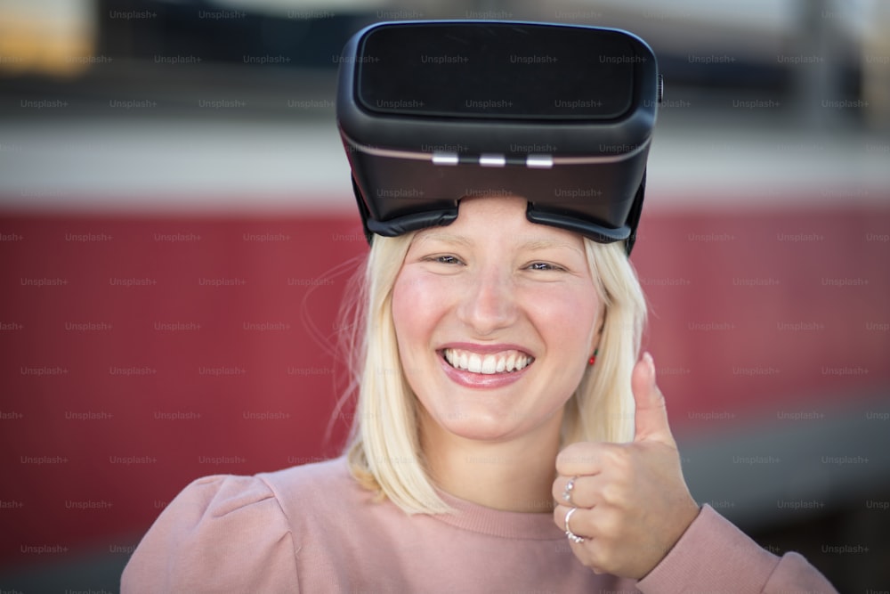 Woman on bus station. Young woman touching experiencing VR helmet.