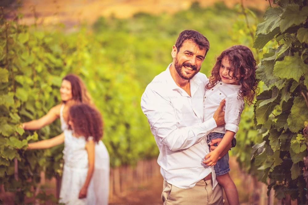 Family in the vineyard. Focus is on foreground.