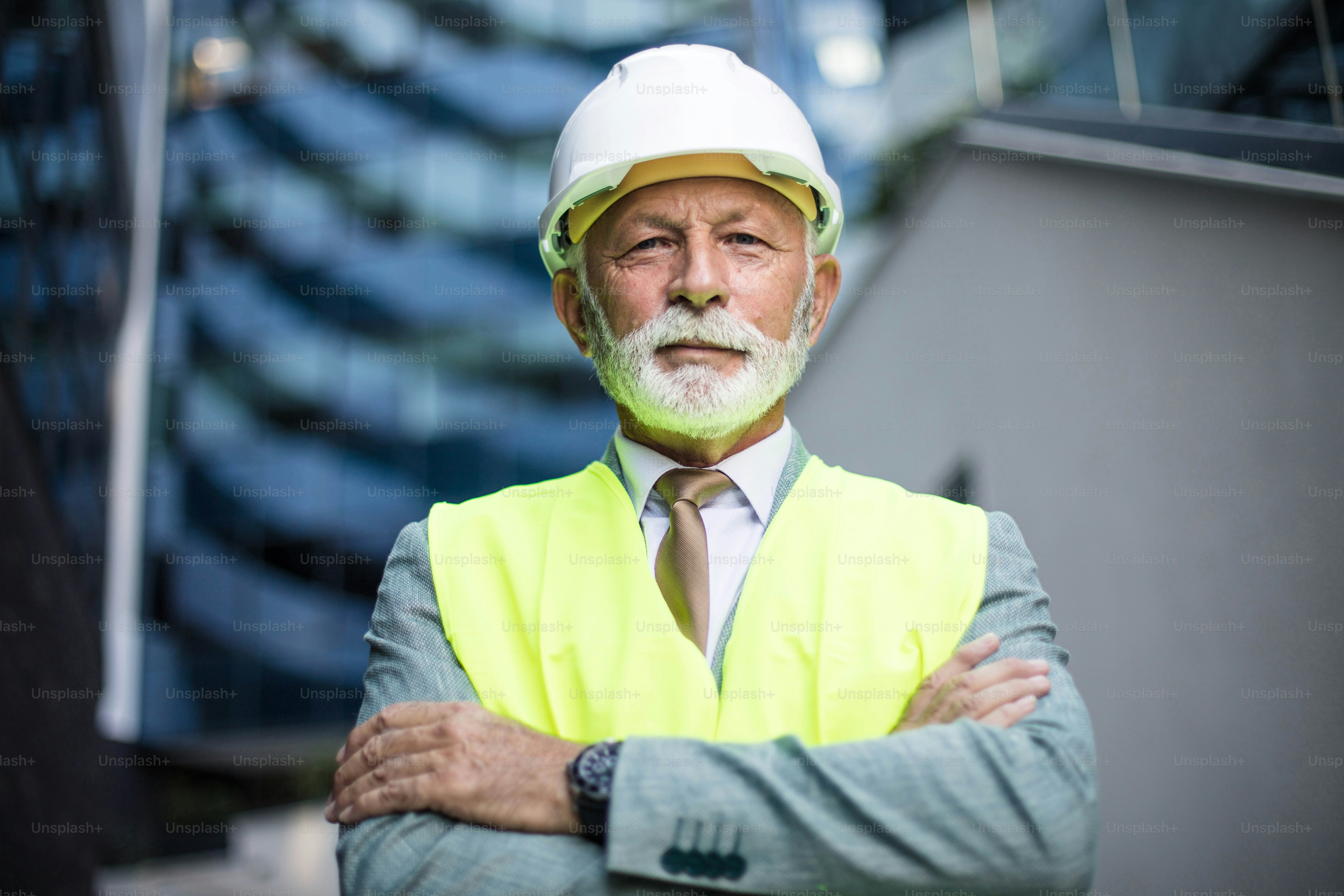 Senior engineer standing on the street. Looking at camera.