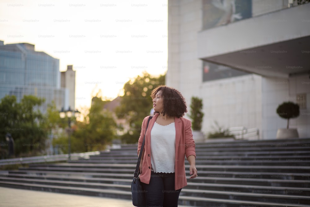 Business woman walking trough city alone.