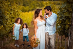 Family in the vineyard. Focus is on couple.