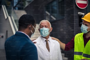 Business man, doctor and engineer talking on street.