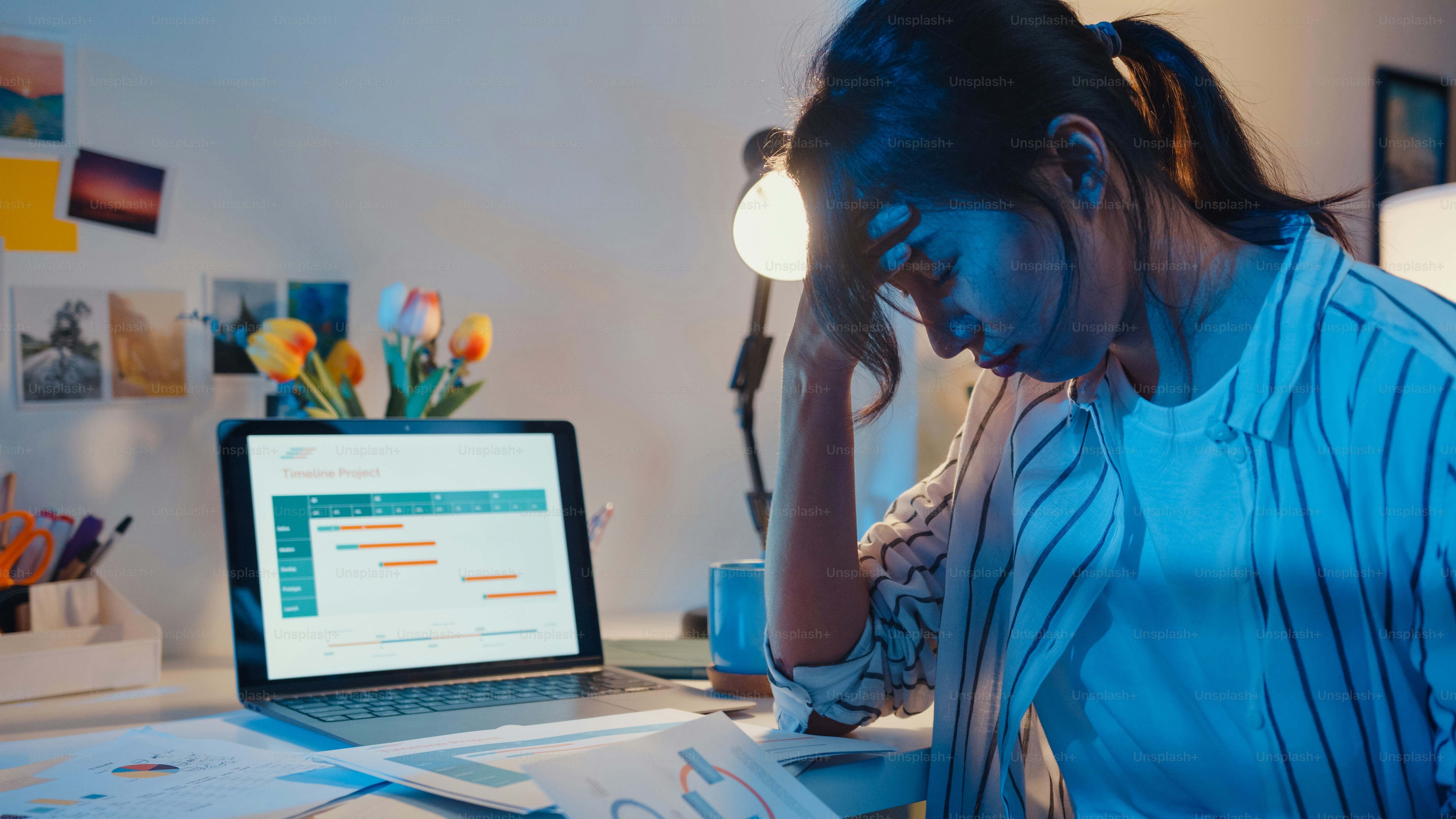 Young asian lady employee work overtime late night stress finance accounting project research on laptop at home. Girl student learn online at house, Social Distance, New normal work from home concept.