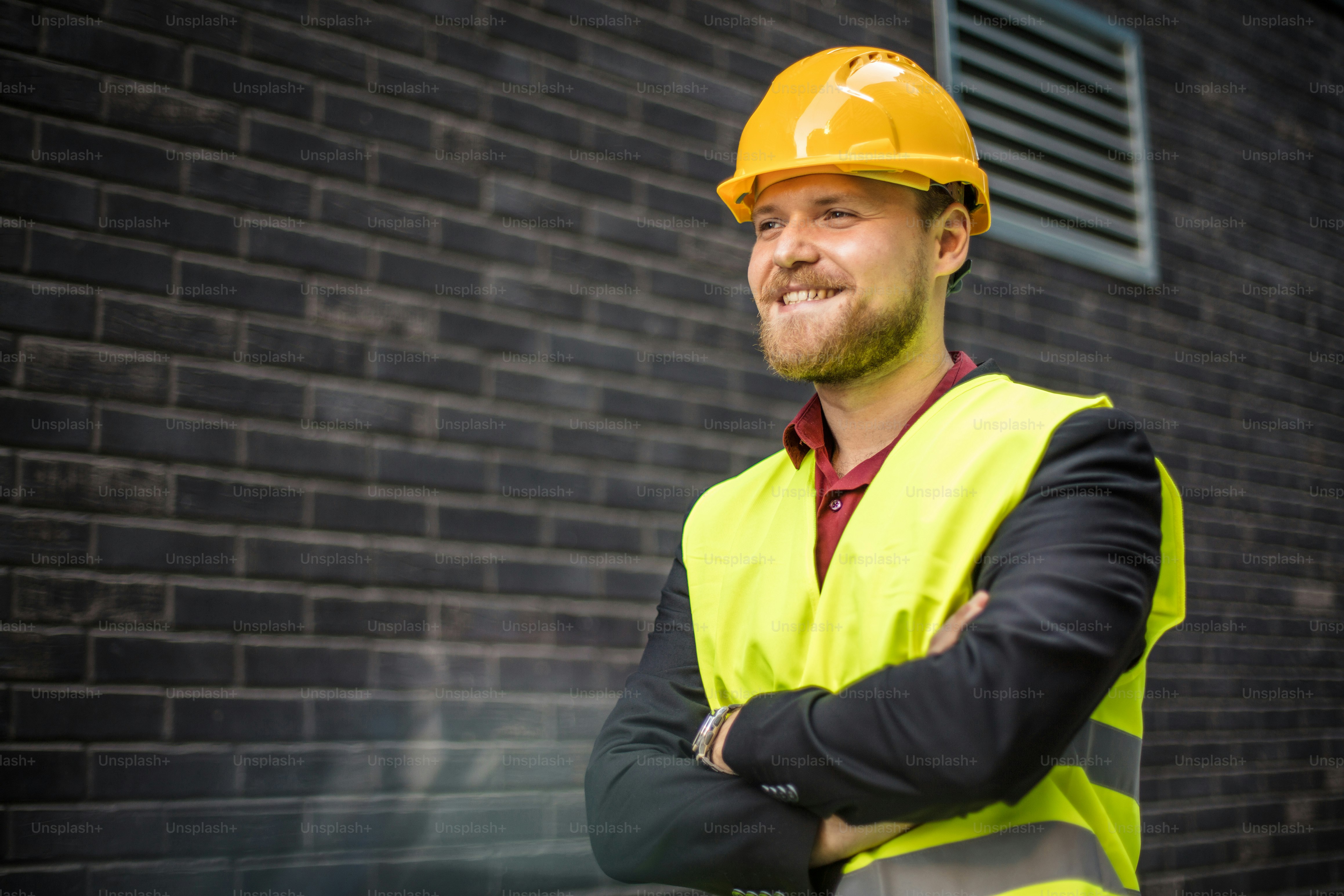 Smiling engineer standing on the street. Cloe up.