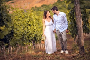 Happy Couple standing and in vineyard.