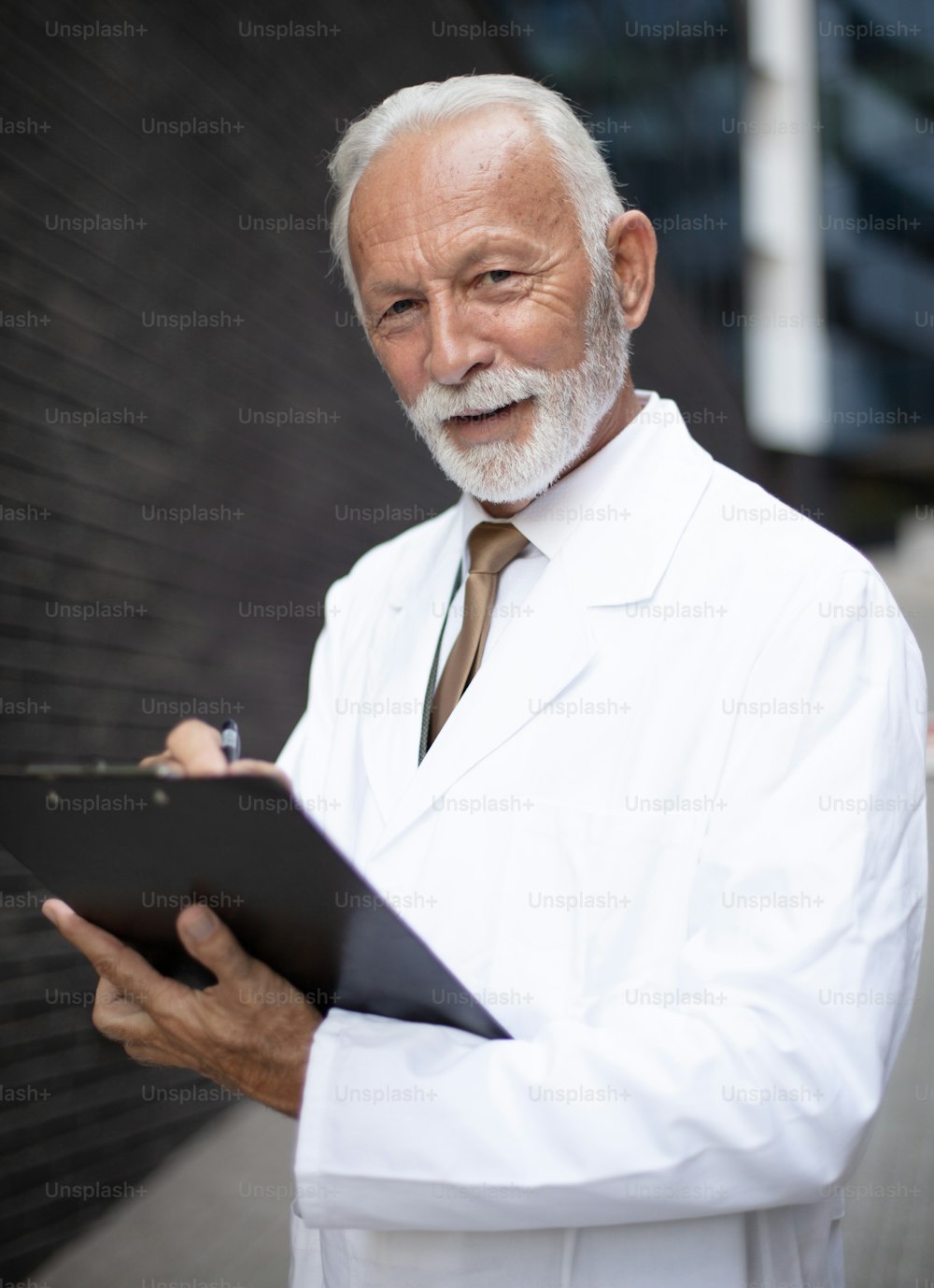 Smiling senior doctor with document.