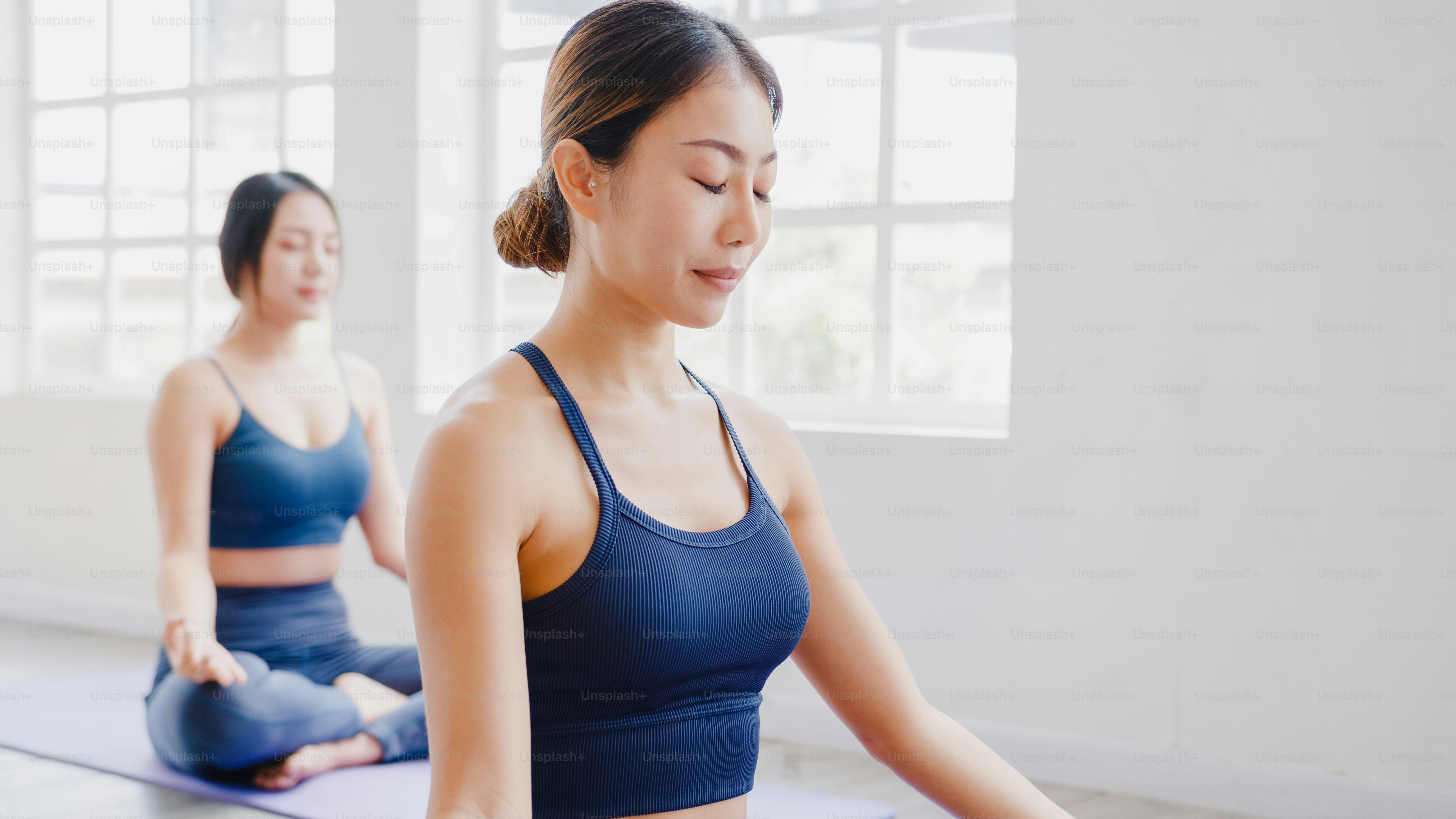 Young Asian Attractive Yoga Professional Instructor Helping A Student To  Strange Her Pose And Body Balance. Well Being Concept. Stock Photo, Picture  and Royalty Free Image. Image 142474764.