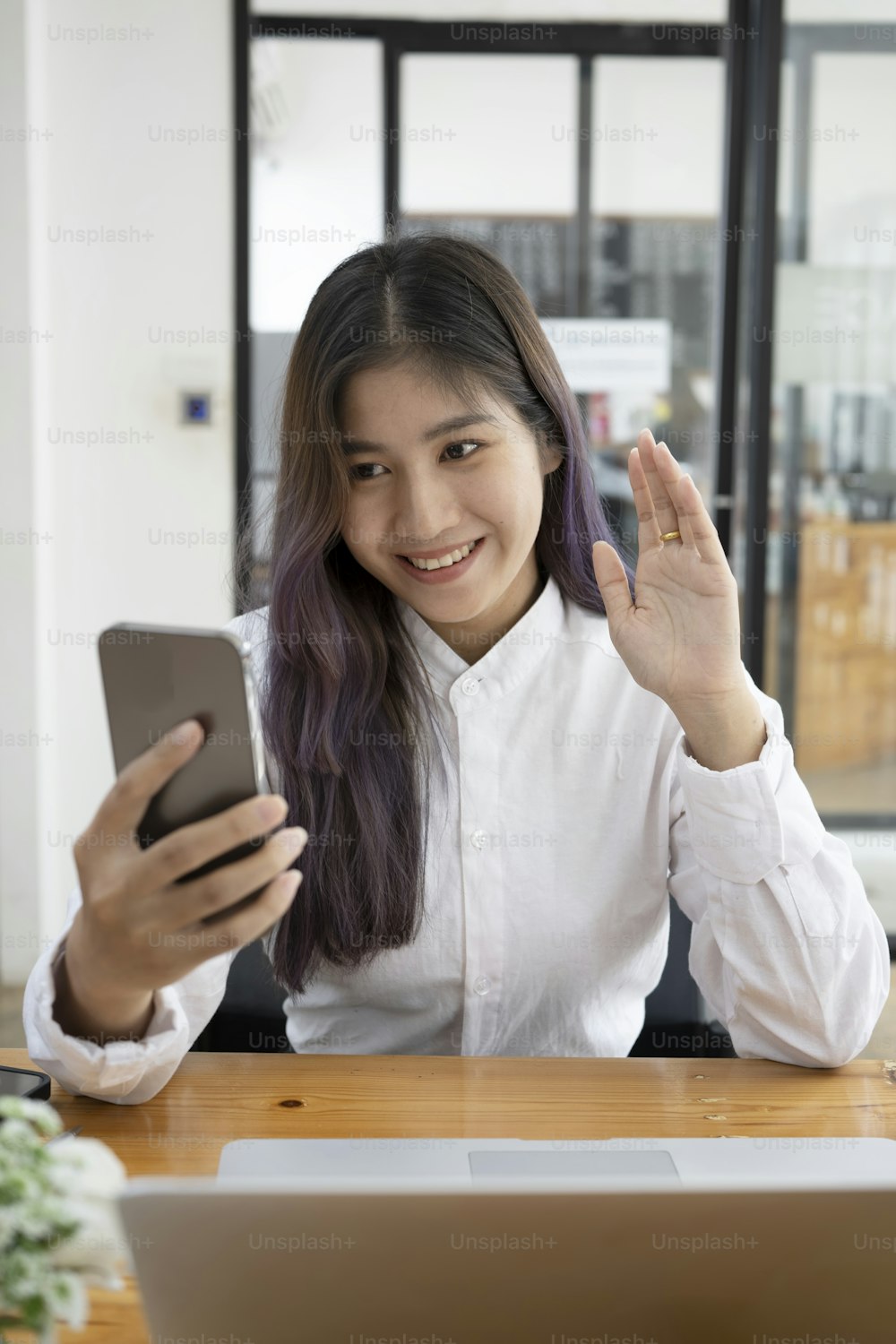 Happy young woman having video call on her smart phone.