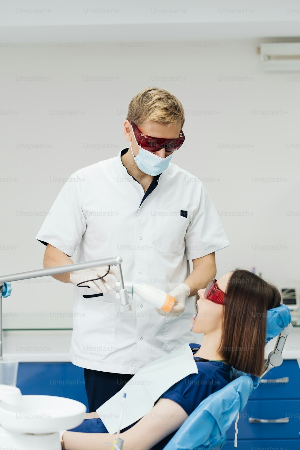 Retrato de primer plano de una paciente femenina que visita al dentista para blanquear los dientes en la clínica