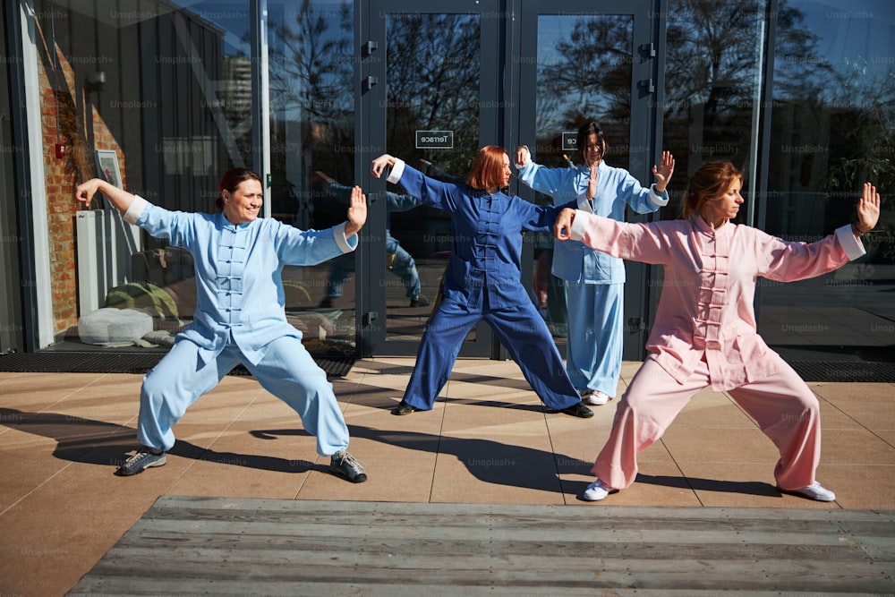 Several ladies doing their best while getting the philosophy of qigong and doing exercises