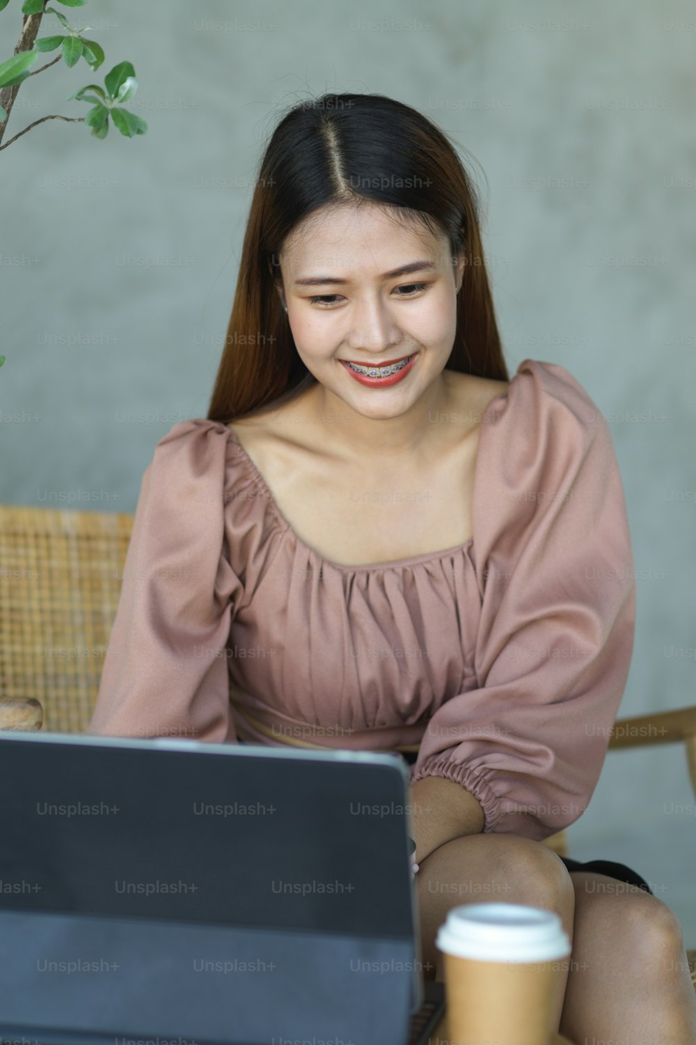 Portrait of female worker smiling while working with digital tablet in cafe