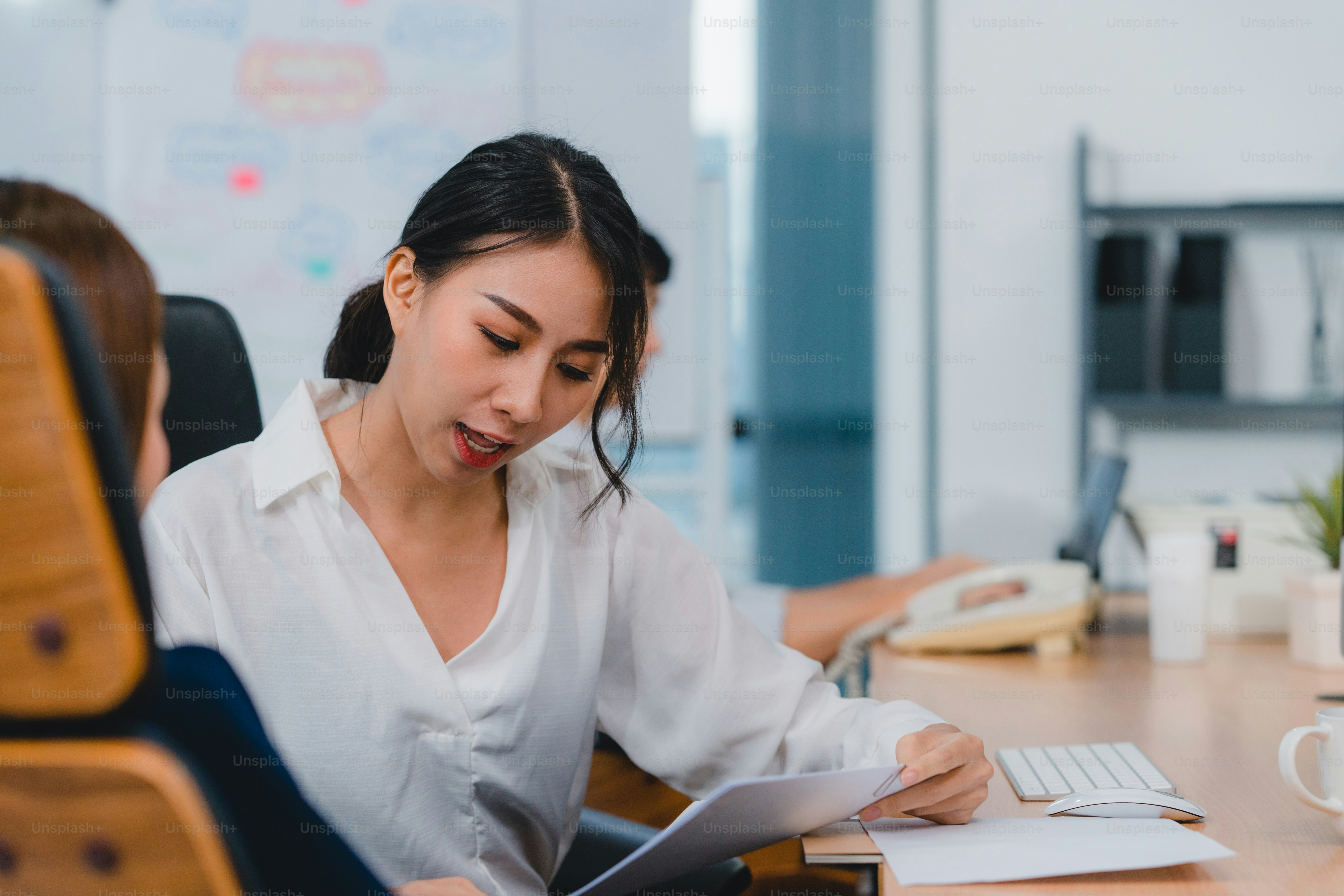 Asia businesspeople chatting to intern discussing job interview colleagues having conversation and meeting brainstorming ideas about project working plan success strategy in office. 4k Slow motion.