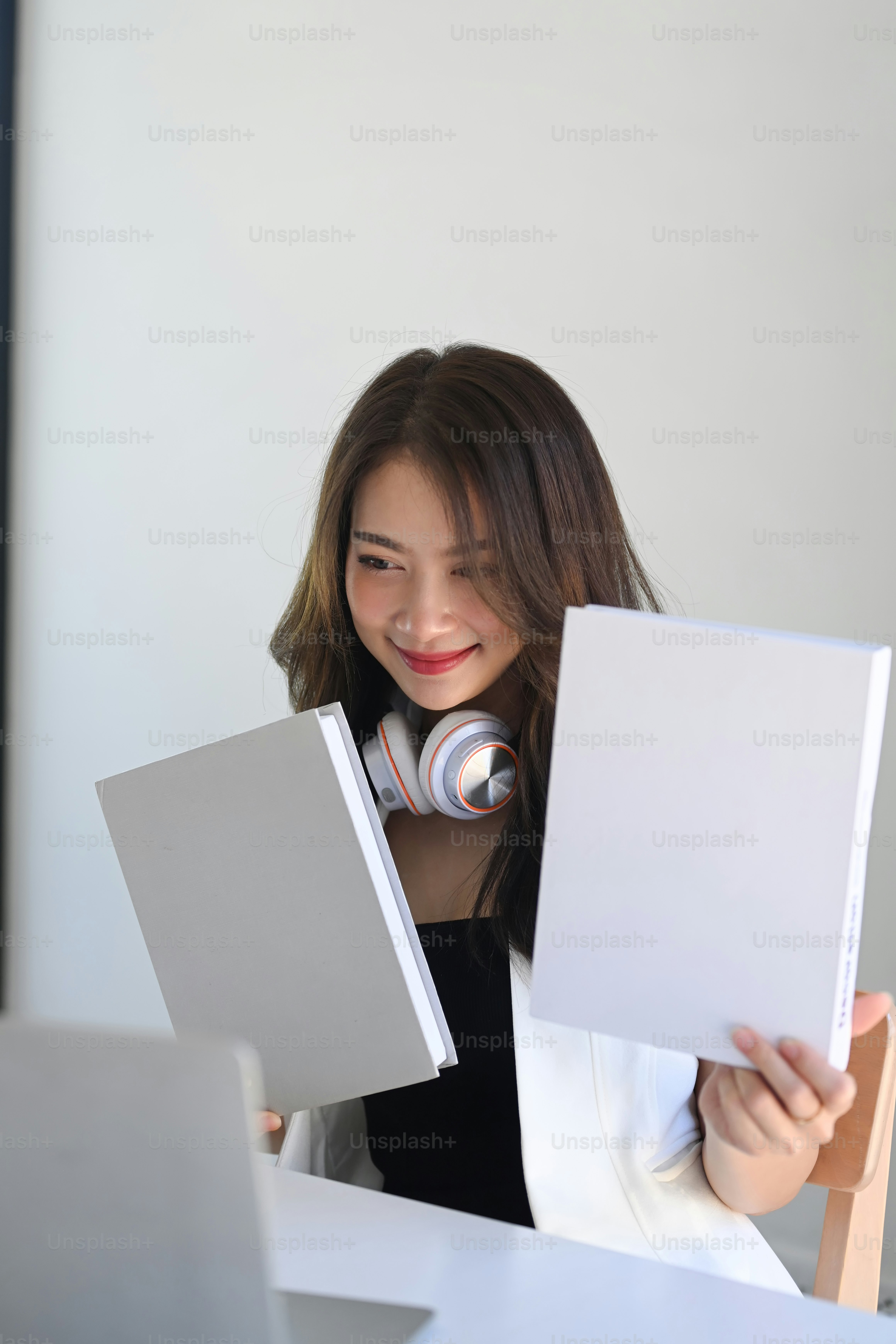 Asian businesswoman having video conference with colleagues and online discussing work at home.