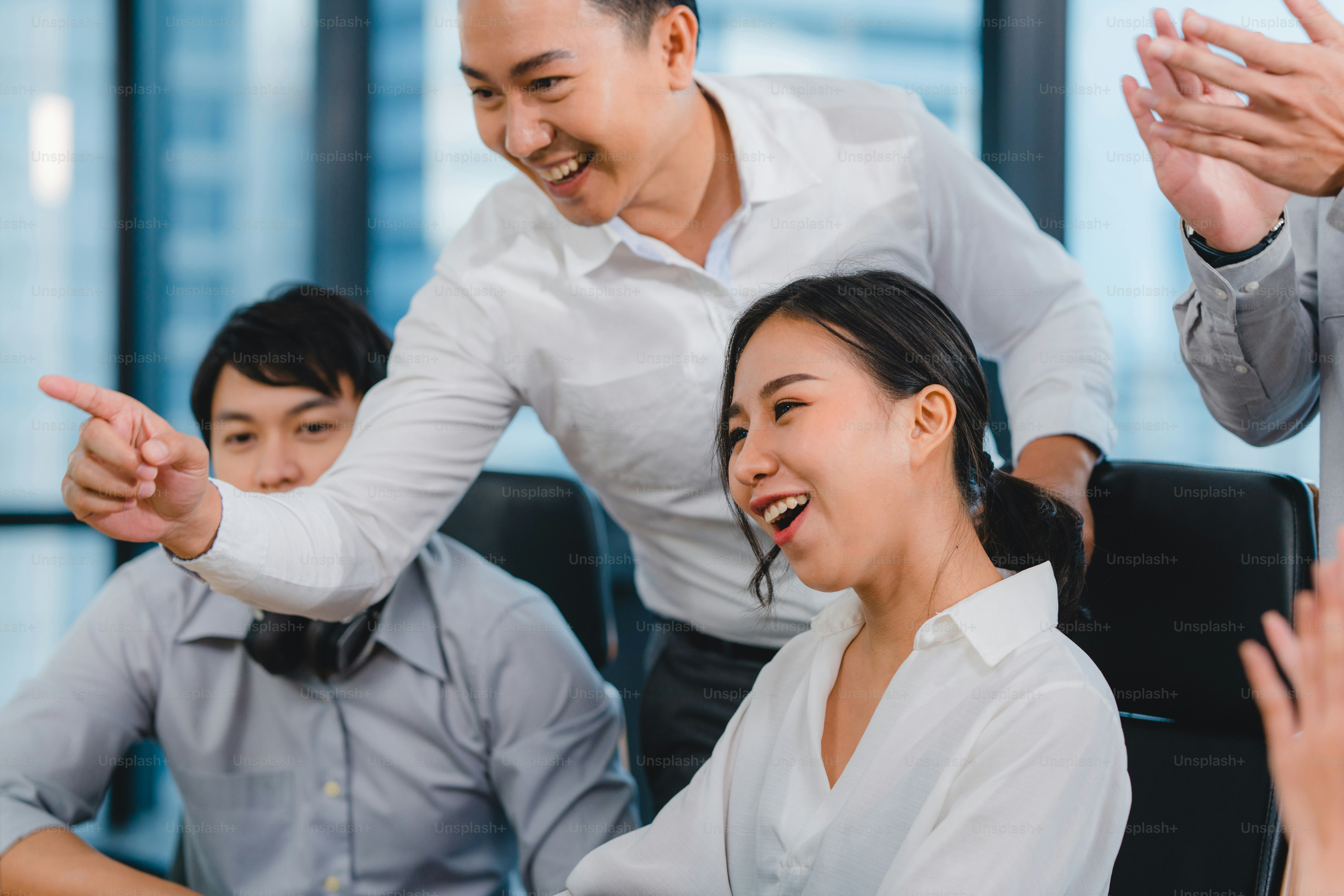 decor - people celebrating in an office looking in the same direction, persons applauding, pointing, or smiling