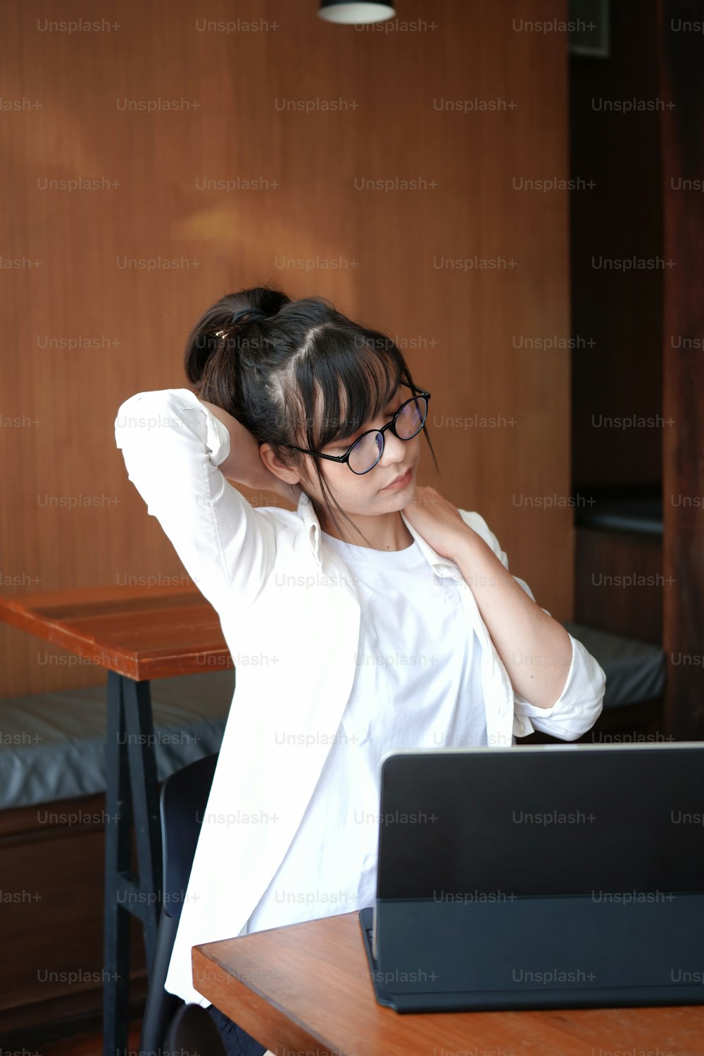 Young woman relaxing at her workplace.