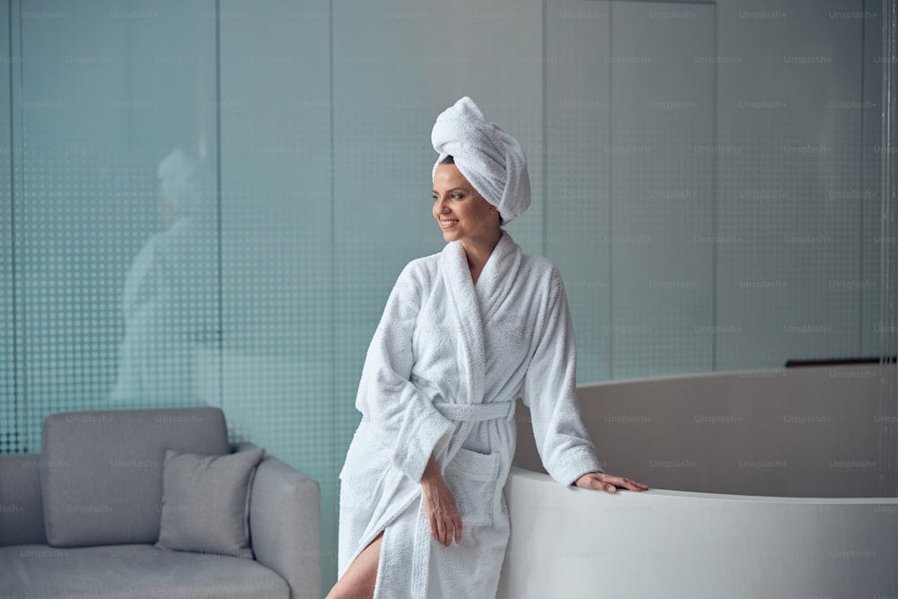 Attractive modern young woman with her hair wrapped in a bath towel in a spa center