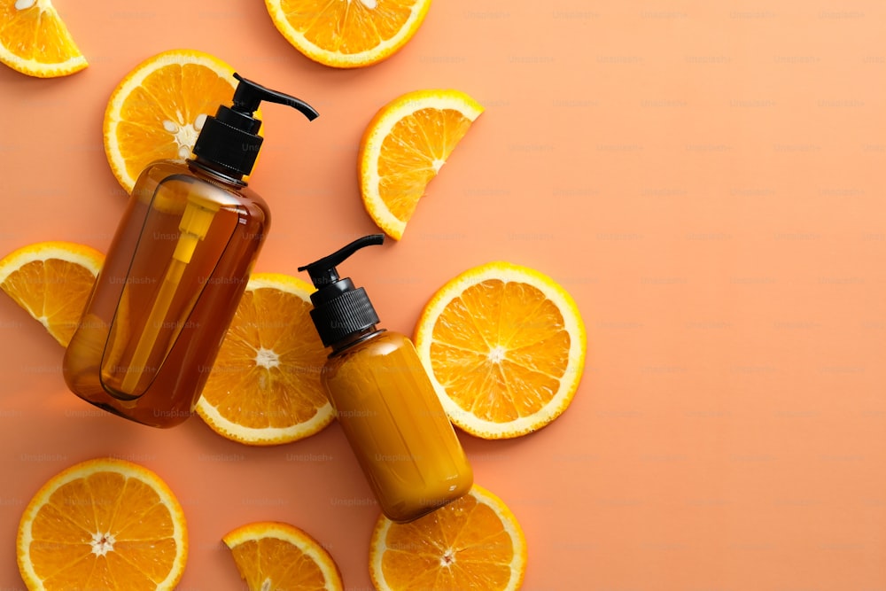 Natural SPA cosmetics with Vitamin C and orange slices on color background. Flat lay, top view.