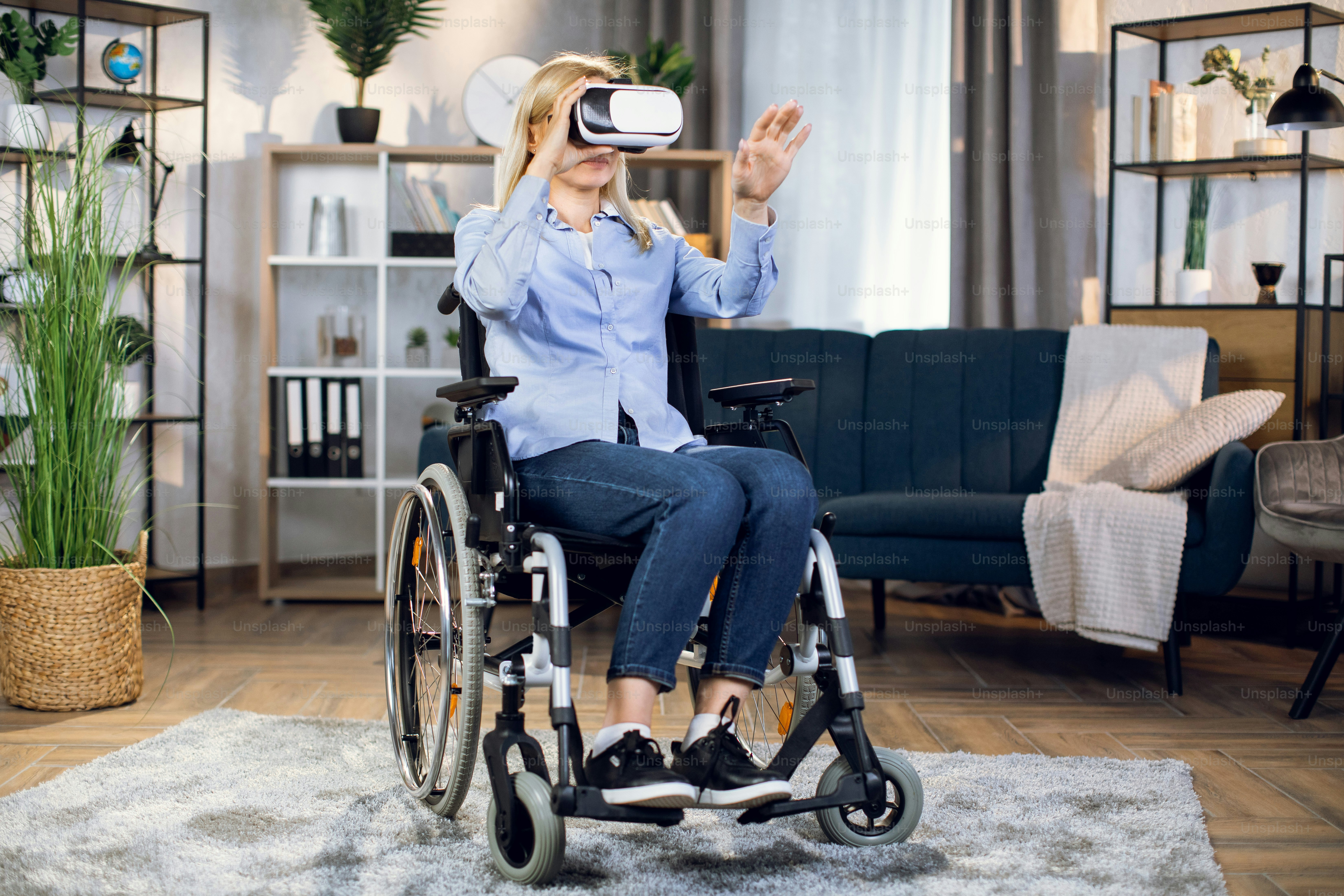 Young woman in wheelchair wearing 3d glasses for enjoying virtual game. Modern innovative technology for disabled people. Rehabilitation concept.