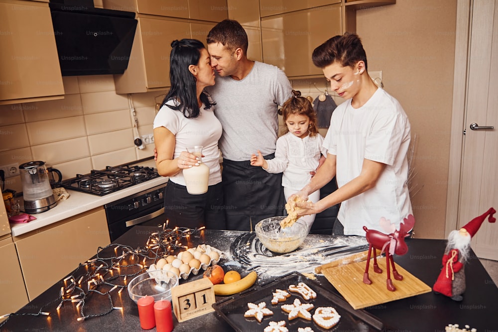 Happy family have fun on the kitchen and preparing food.