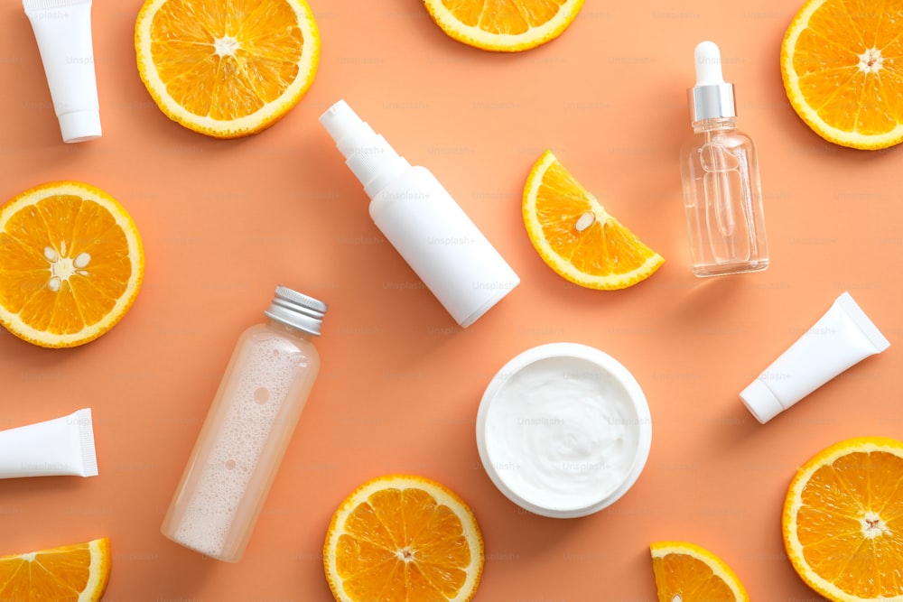 Natural cosmetics and orange slices. Flat lay, top view. Vitamin C citrus beauty products. Skincare concept.