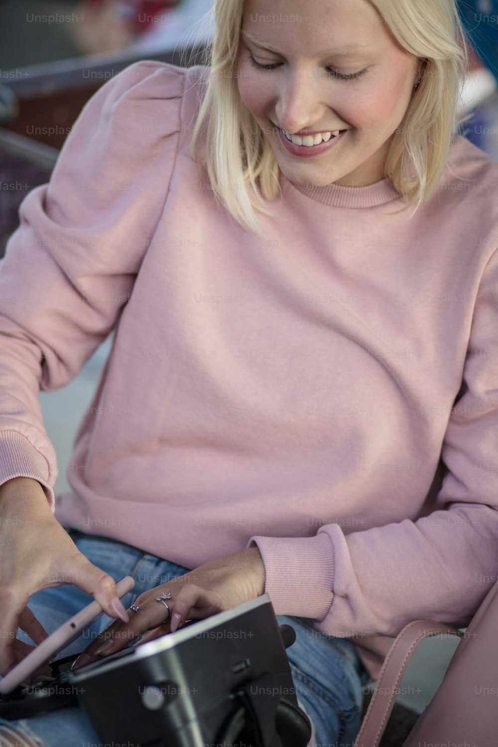 Time for virtual fun.  Woman on bus station. Young woman holding VR helmet.