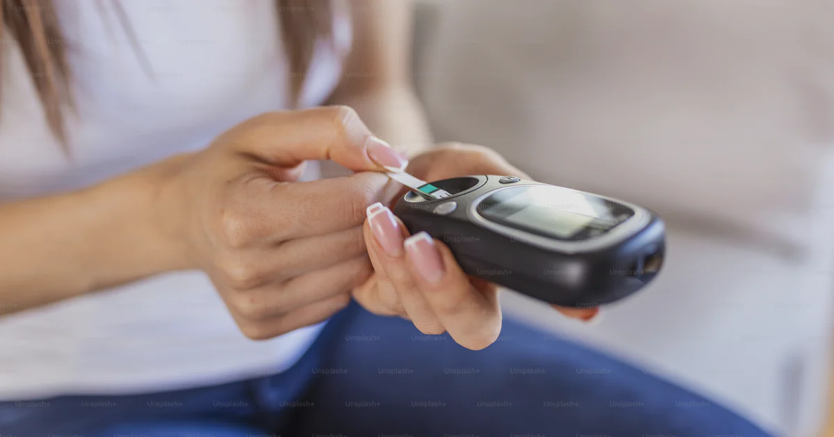 Woman Using Glucometer Woman with glucometer checking blood sugar level at home. Diabetes ...