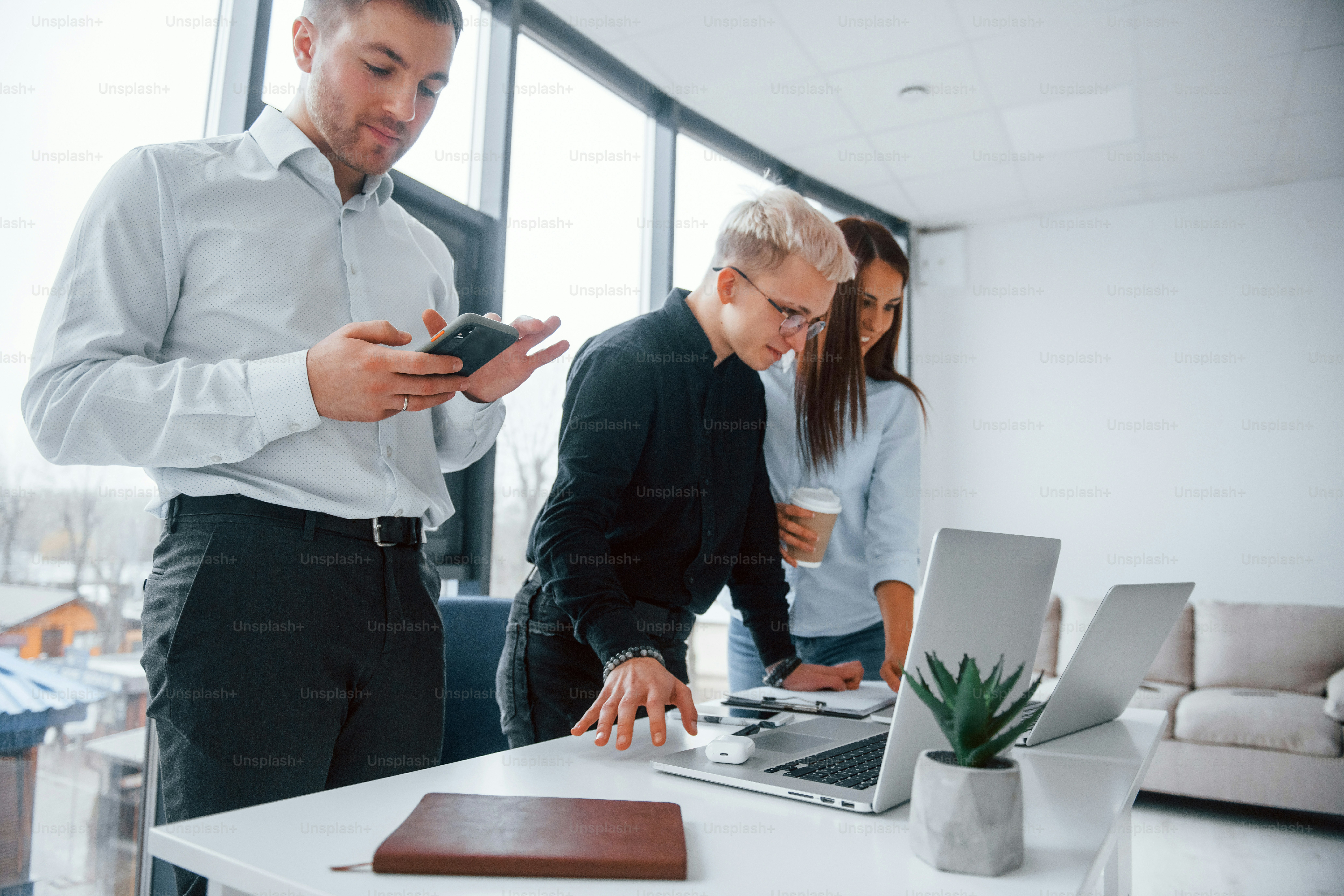 Group of young successful team that working and communicating together indoors in office.
