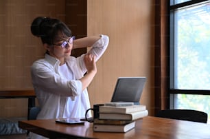 Young asian woman designer relaxing at her workplace.