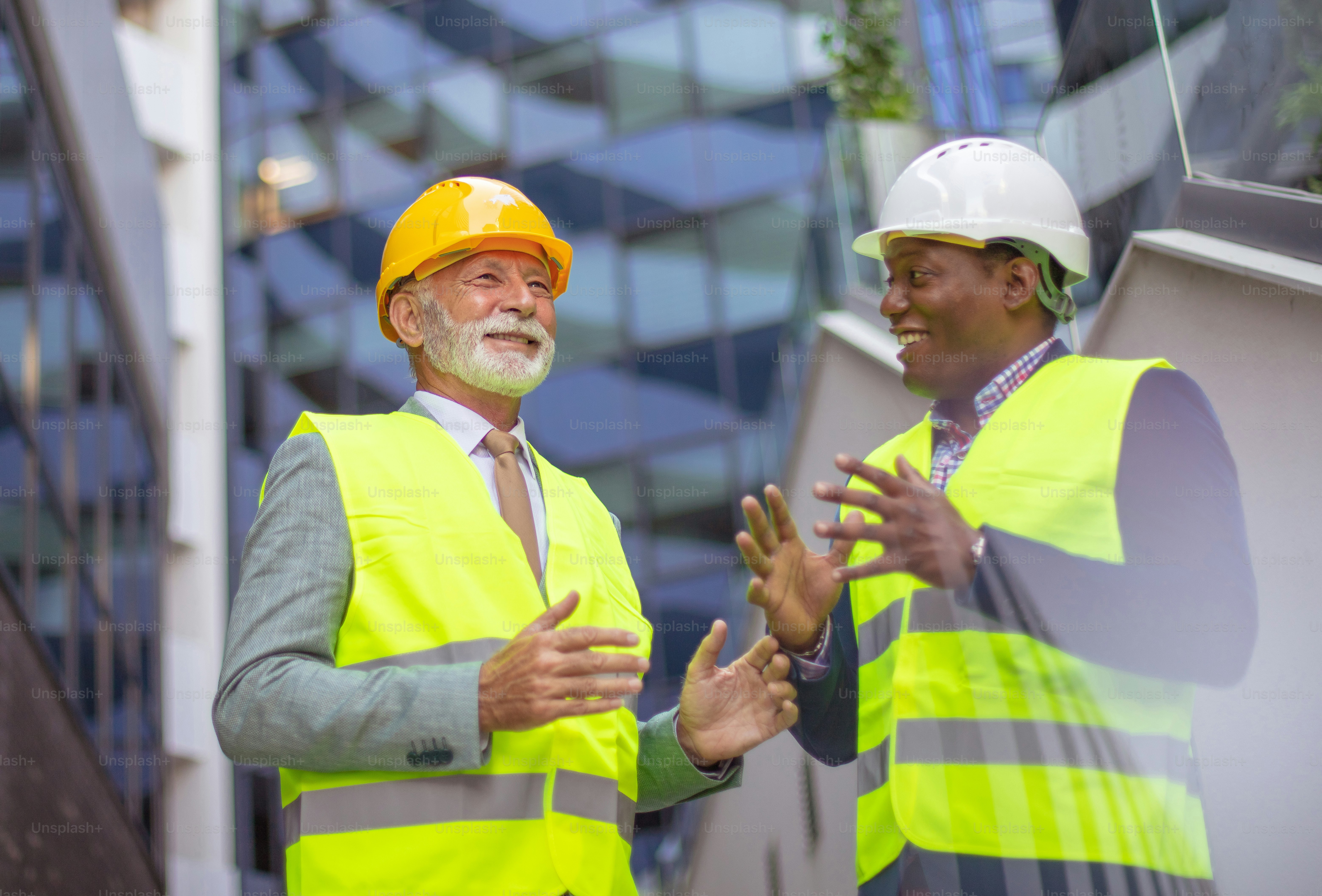 Mature engineer discussing the structure of the building with ...