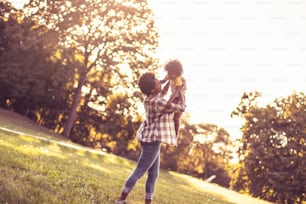 African mother and daughter playing in the park.