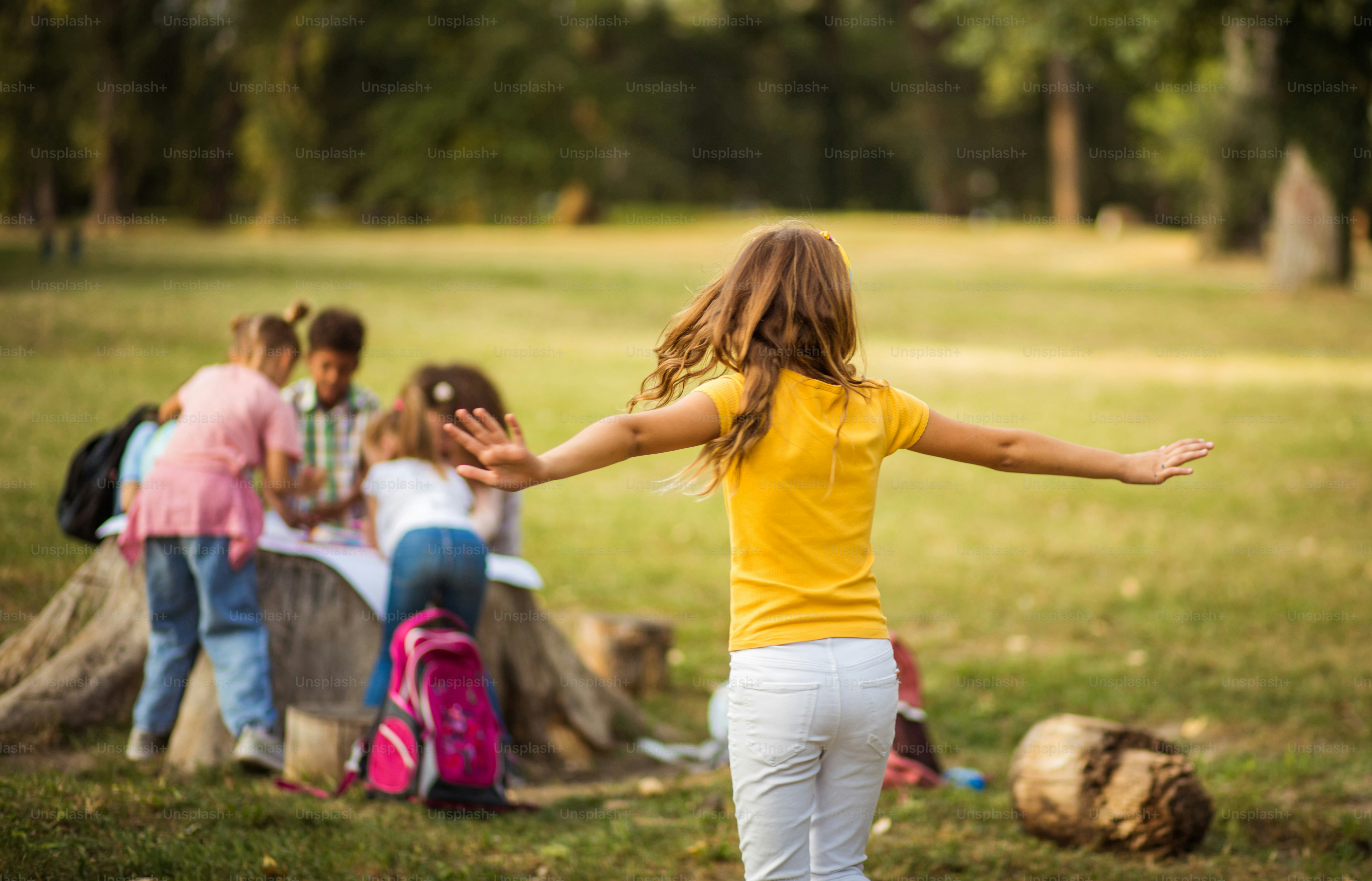 Large group of school kids in nature. Portrait of school girl.