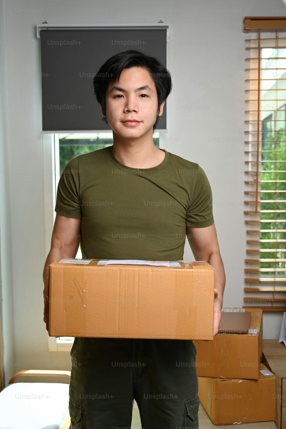Asian man business owner prepare product packaging cardboard box for customer.