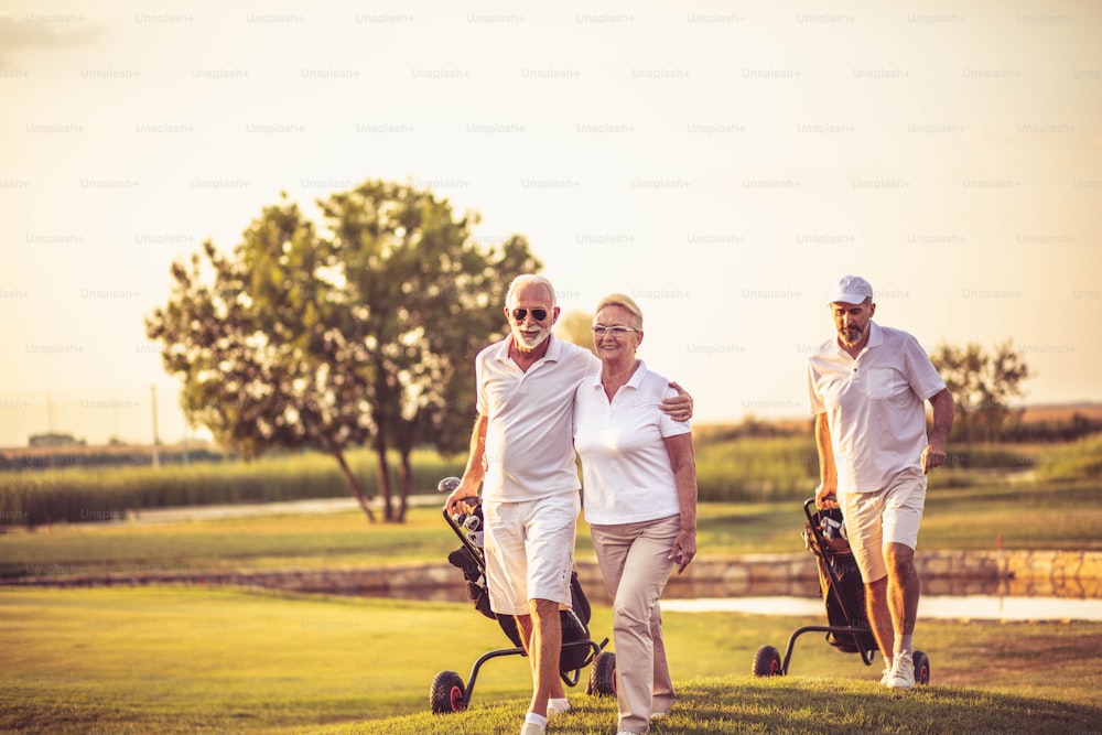 Glückliche Senioren Golfer. Mann und Frau stehen im Mittelpunkt.