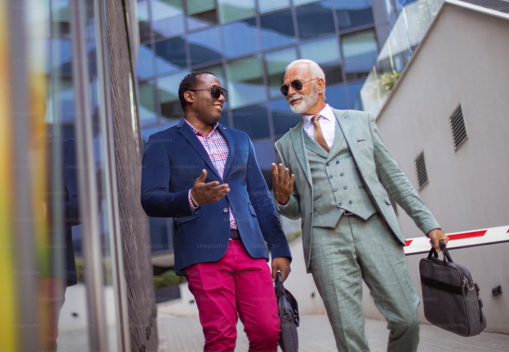 Two business men talking on the street. Going on work.