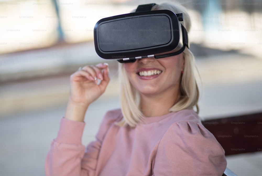 Virtual world. Young woman with VR helmet. Woman on bus station.