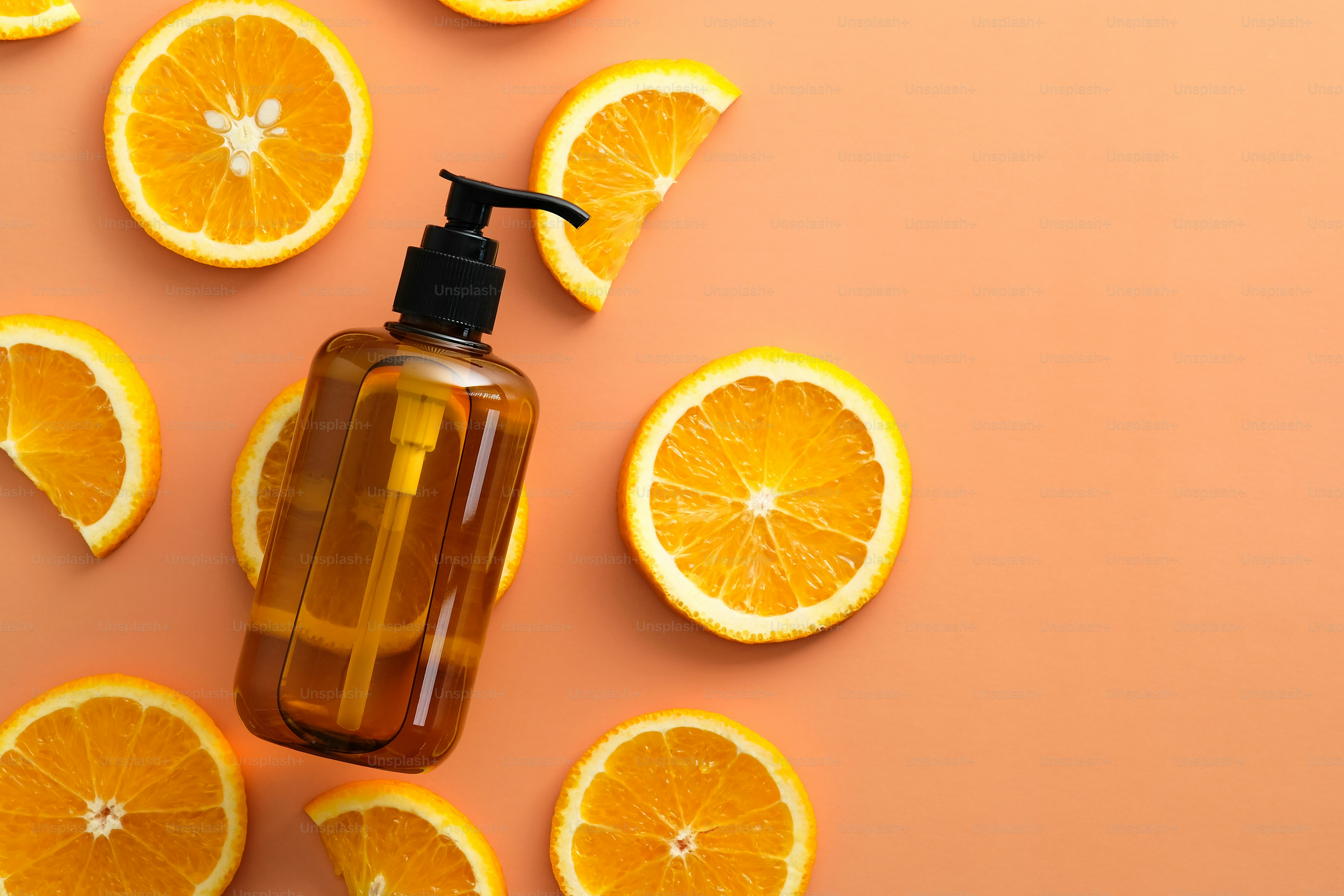 Bouteilles de shampoing en verre ambré avec vue de dessus orange tranchée. Cosmétiques naturels aux fruits SPA.