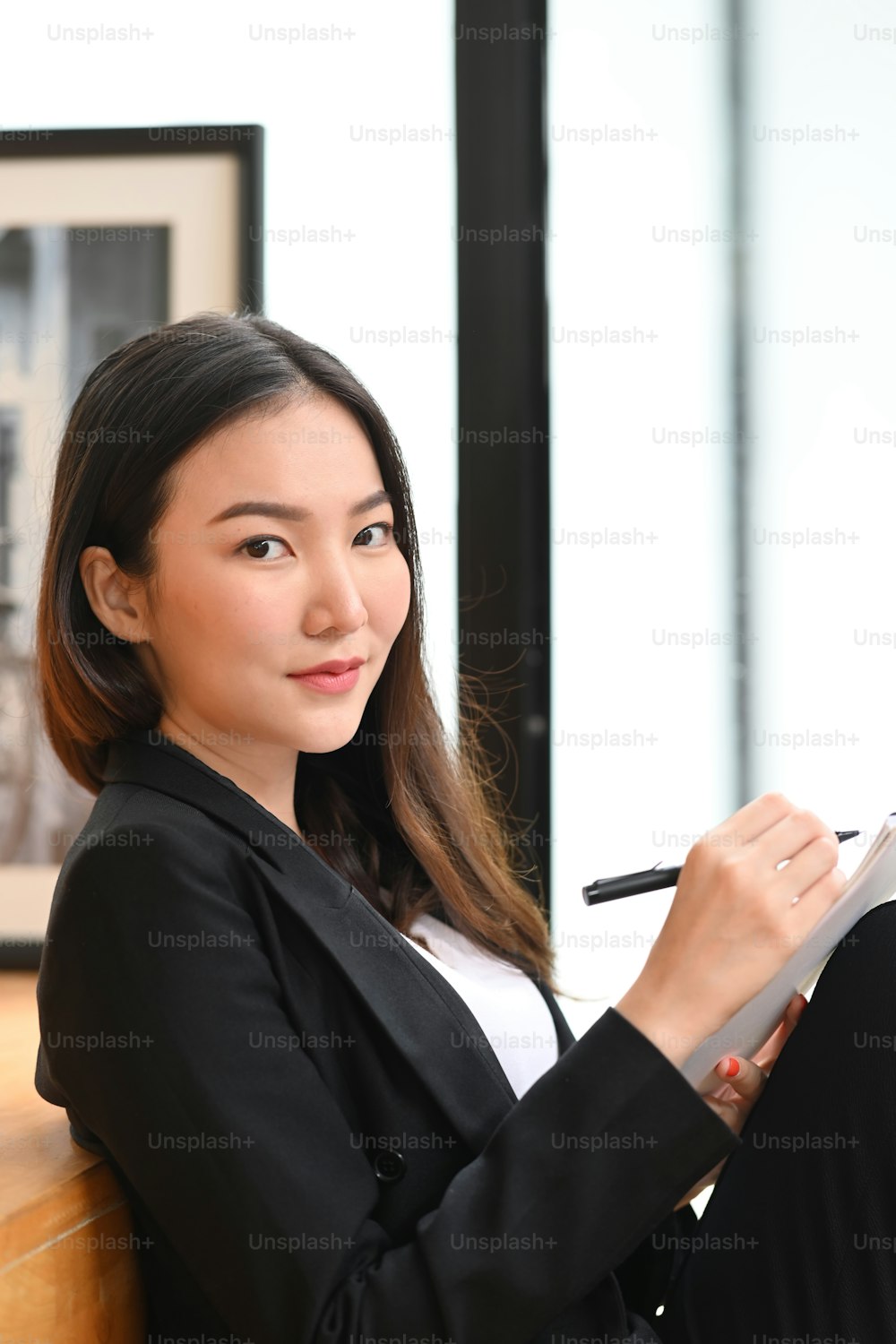 Portrait of attractive businesswoman holding digital tablet and looking a camera.