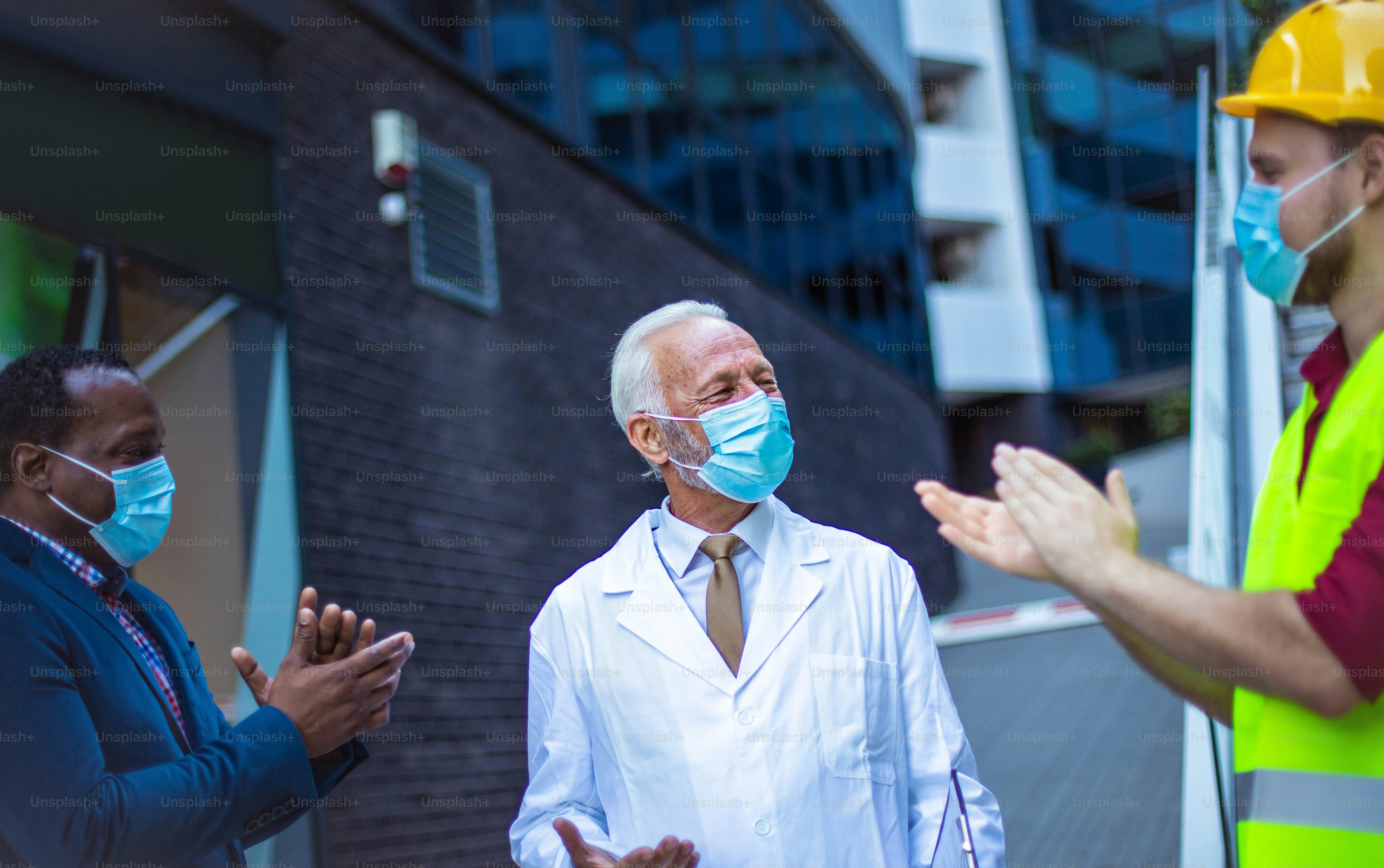Business man, doctor and engineer talking on street.