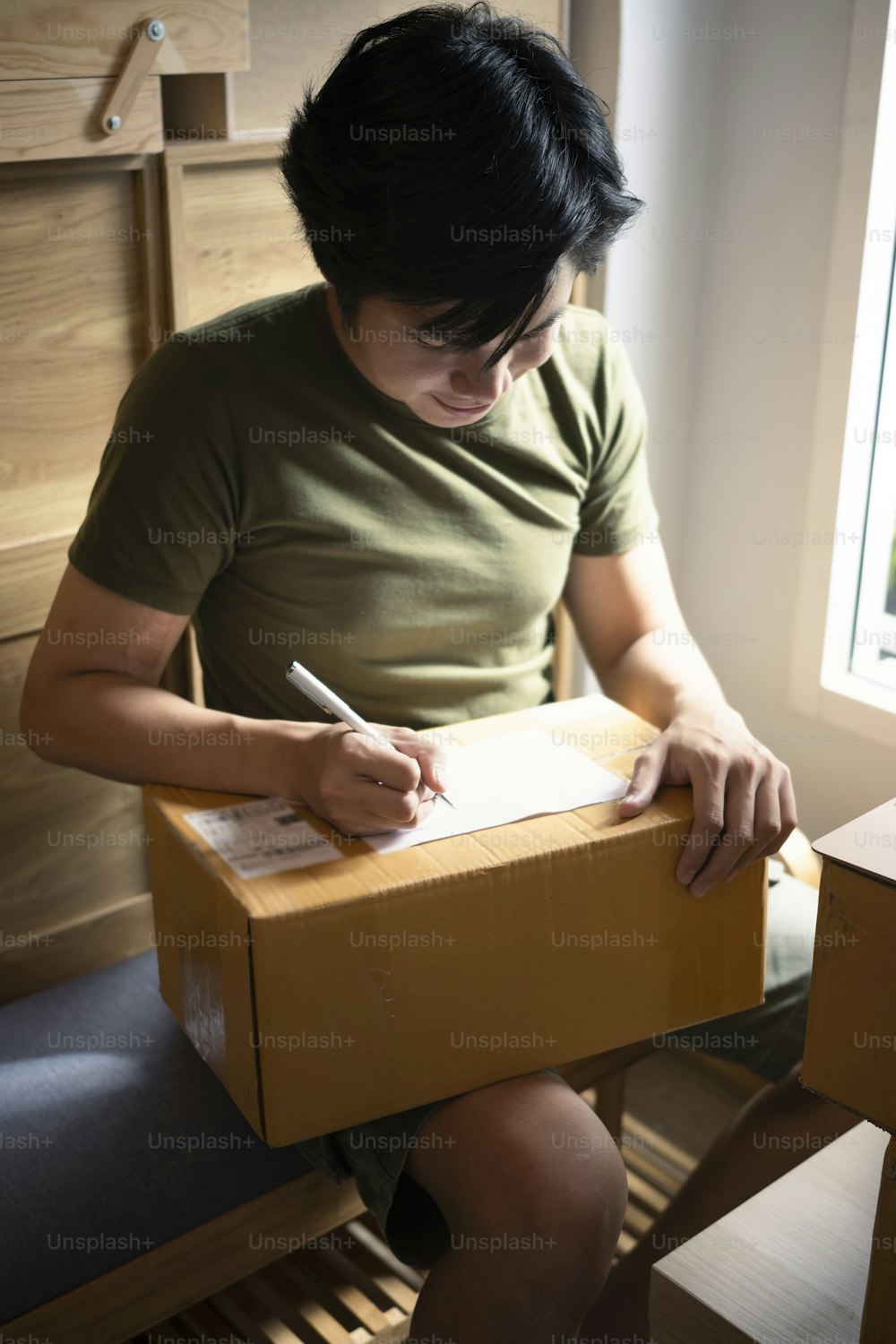 Startup small business owner working at home and preparing product packaging cardboard box for customer.