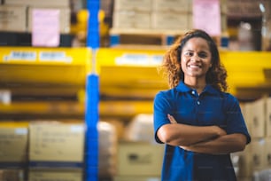 A close up portrait of women who working in the wearhouse storehouse, empower women, foreman, employee, working concept, american african brown curly hair.smiling ypung adult girl in uniform.